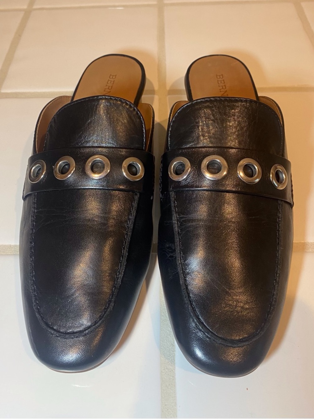 Bernardo Black Leather Slip-On Loafers with Silver Grommet Accents